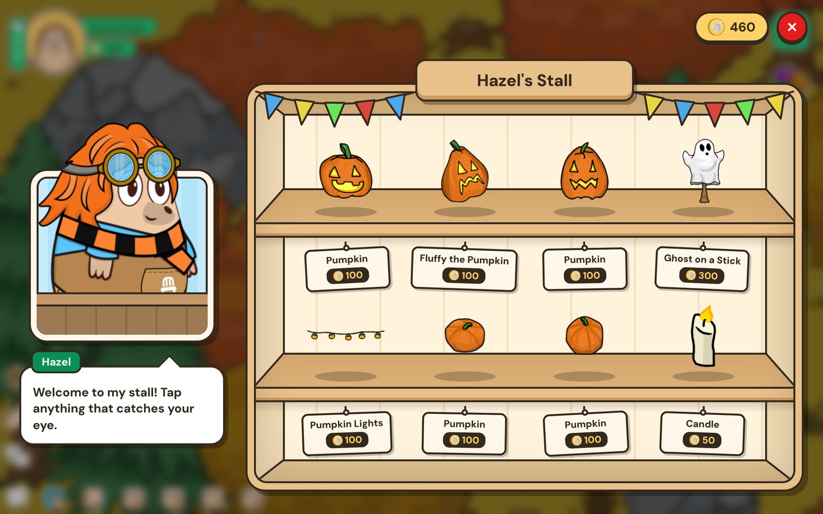 Hazel's stall full of pumpkins, a ghost on a stick and a candle on wooden shelves